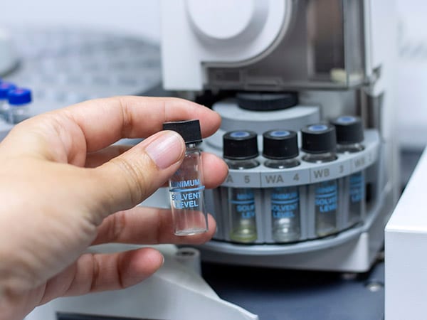 Laboratory concept: close up picture of handhold the sample vial